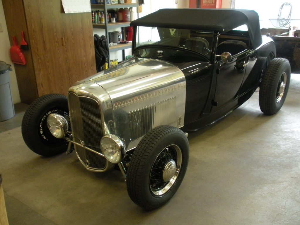 A black and silver car is parked in the garage.