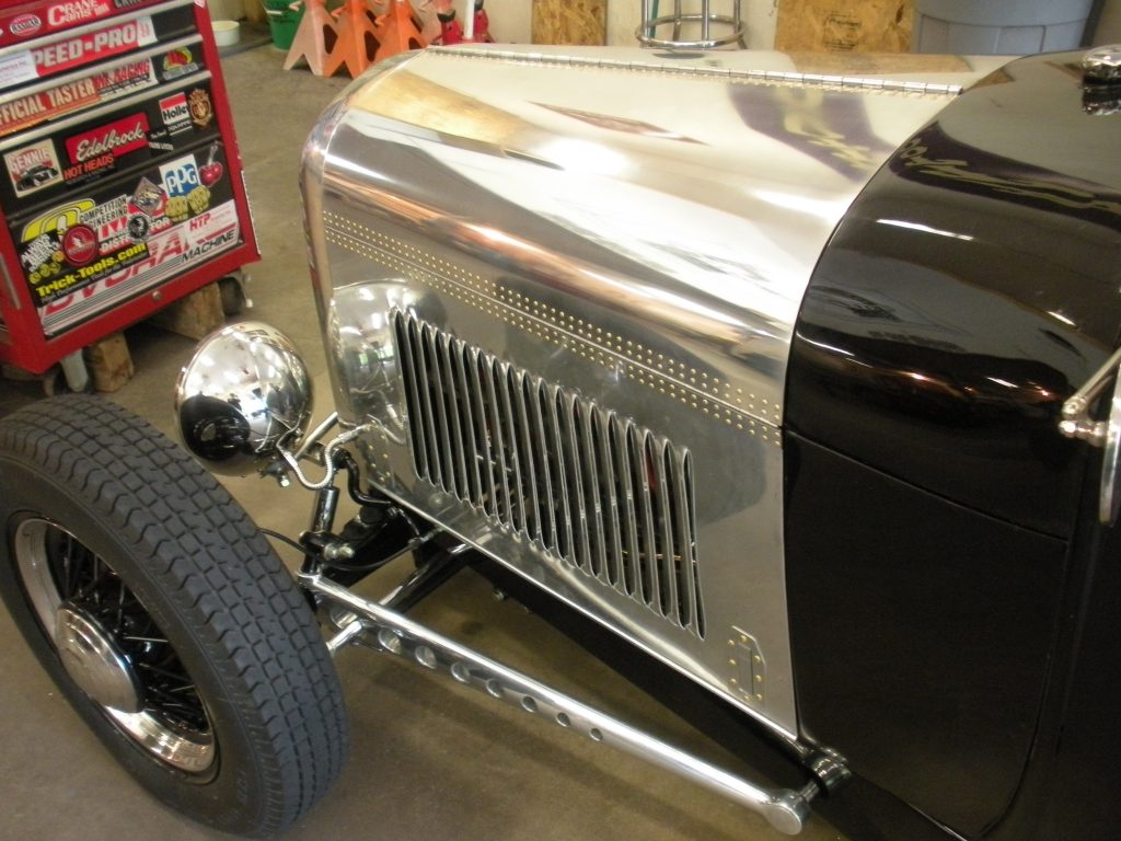 A close up of the grill on an old car