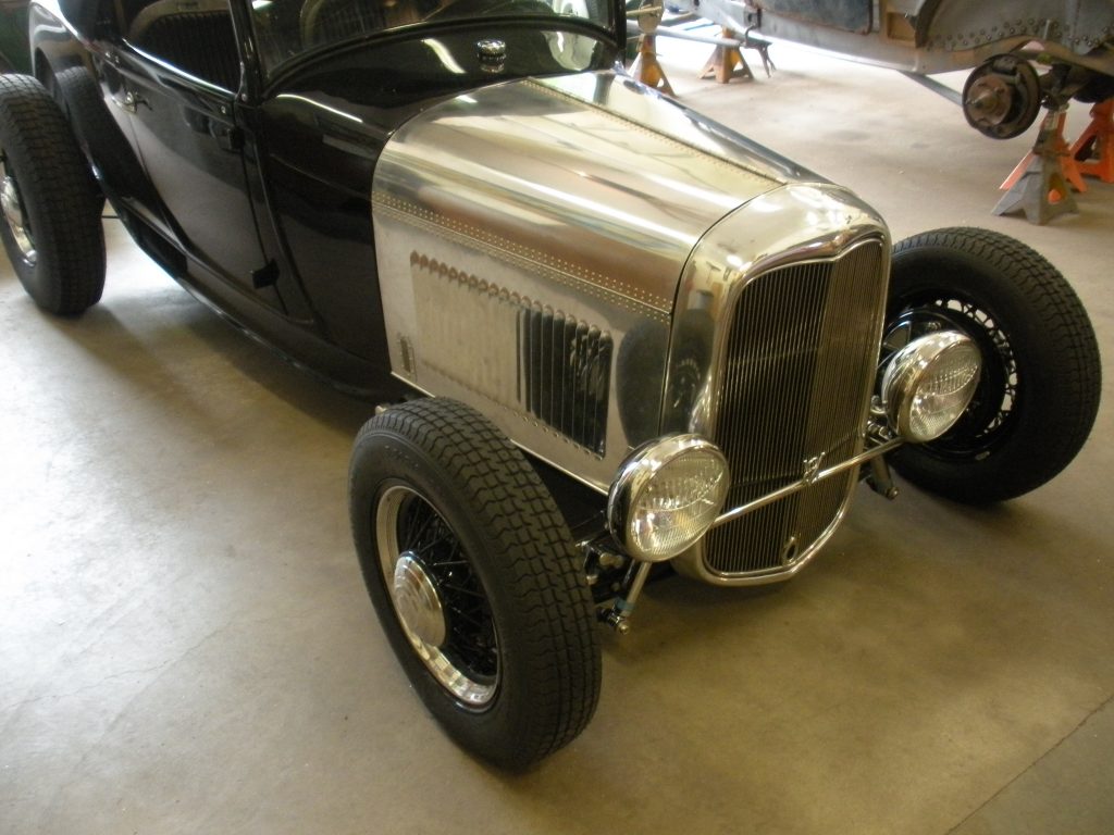 A black and silver car parked in a garage.