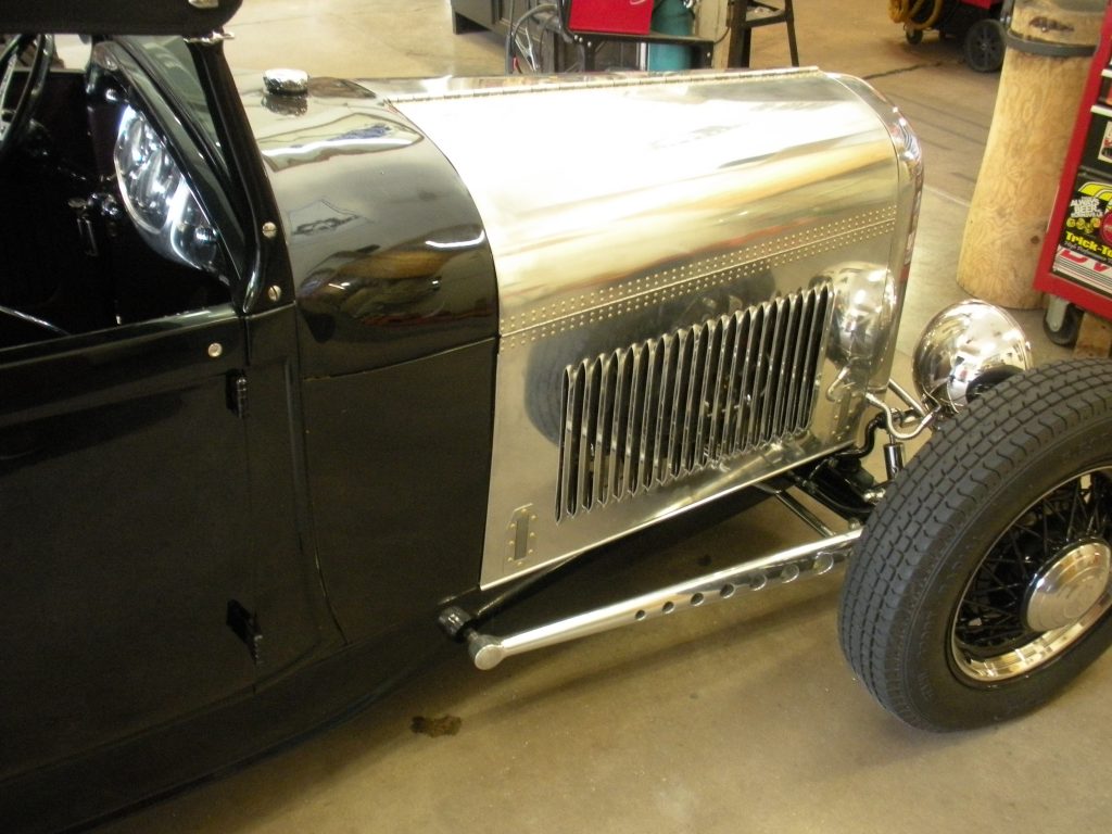 A black and silver car parked in a garage.