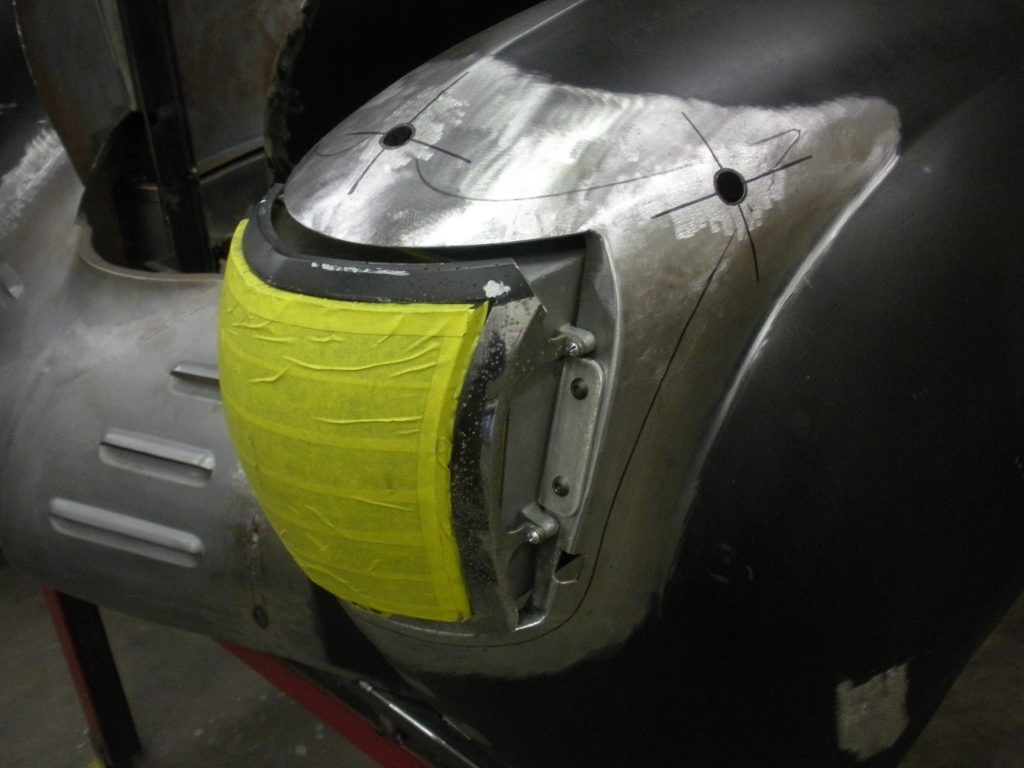 Car fender headlight installation progress.