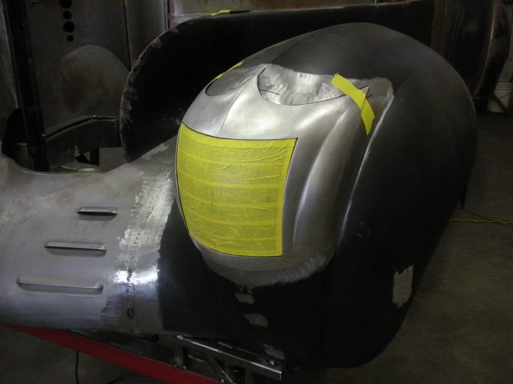 Here's an alt tag for the image: Car body fender repair in progress.
