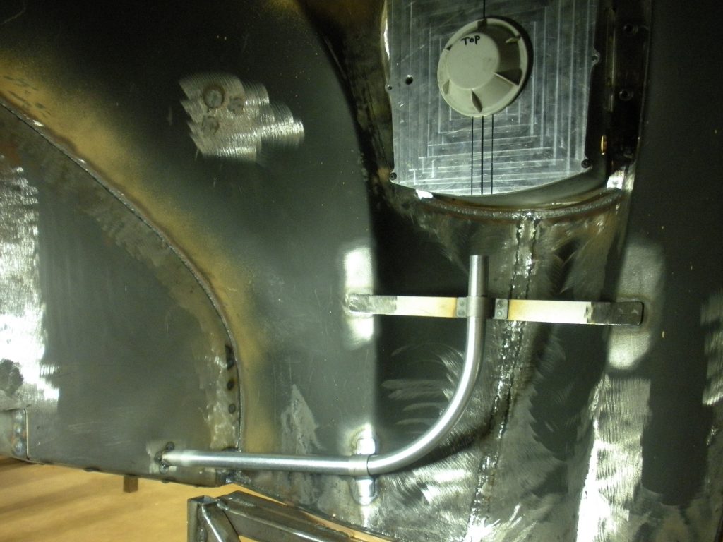 Welded metal pipe and fan assembly.