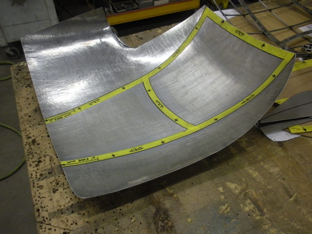 Metal sheet with assembly steps marked.