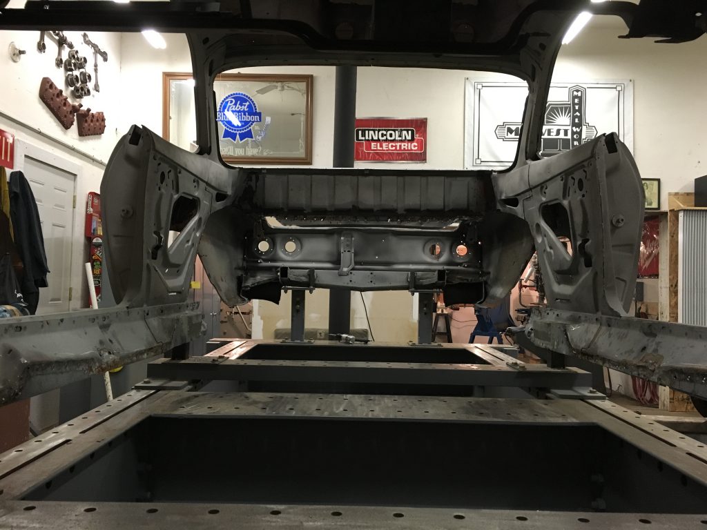 A car is being worked on in the shop.