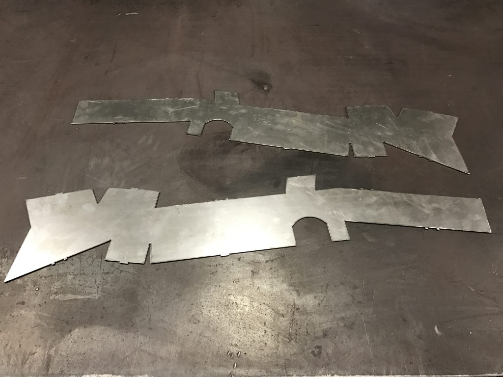 A metal piece of art that is cut out.