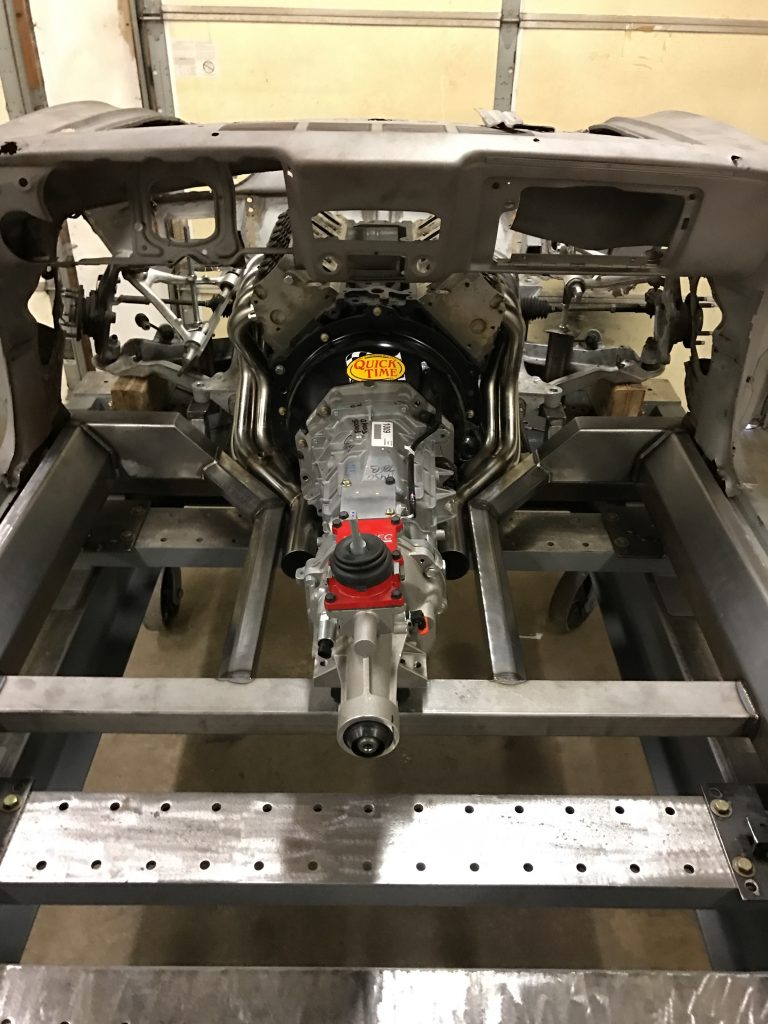A car engine is being built in the shop.