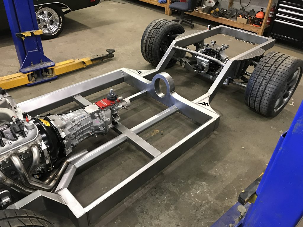 A car frame with the engine exposed.
