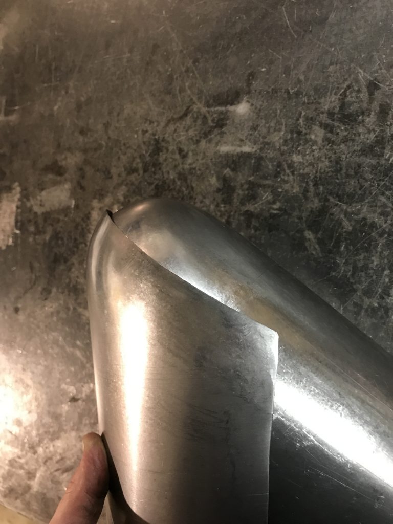 Metal gas tank being constructed.