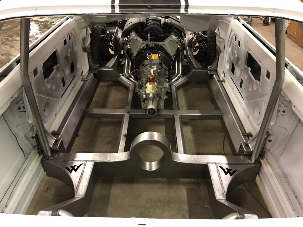 A car frame with the floor exposed.