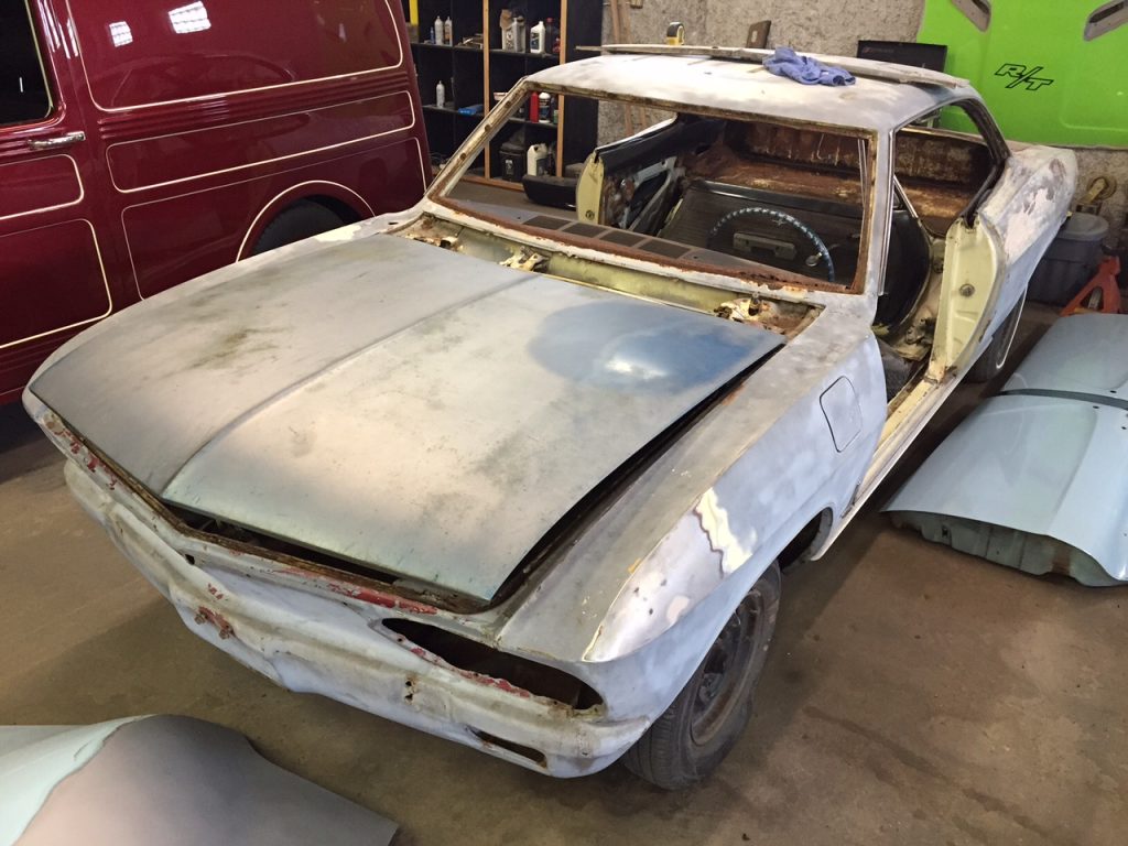 A car that is being worked on in the garage.