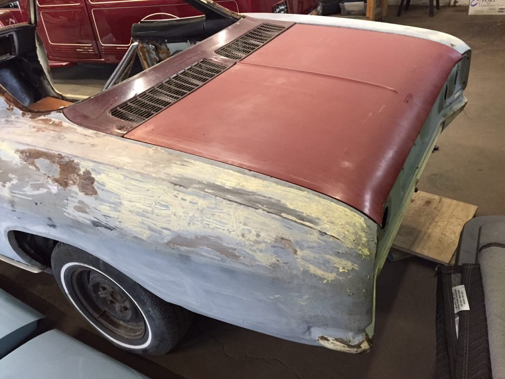A car that is sitting in the dirt.