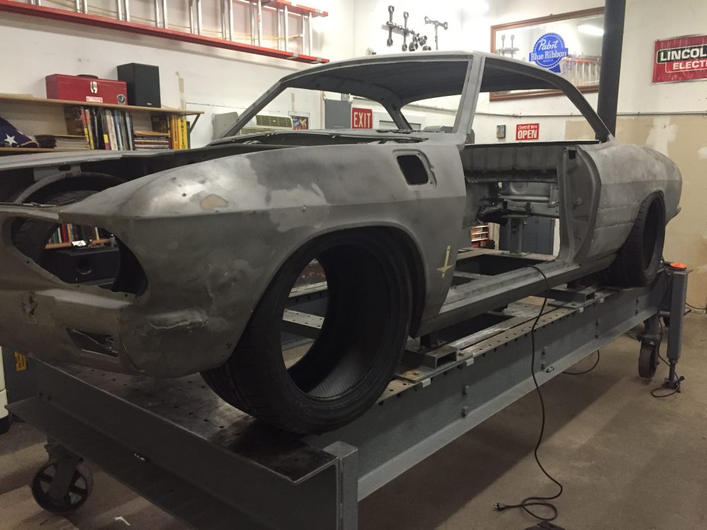 A car is being worked on in the shop.