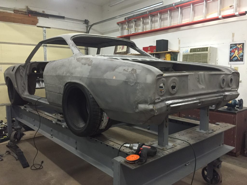 A car is being worked on in the shop.