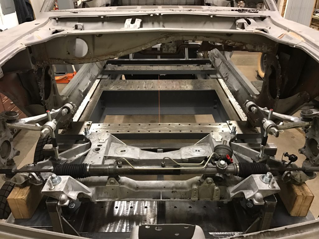A car frame being worked on in an assembly shop.