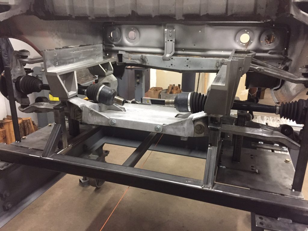 A car frame being worked on by a machine.
