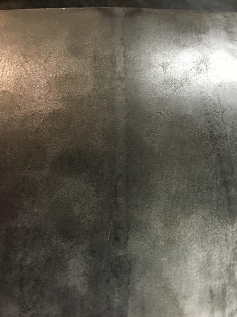 Dark gray textured metallic surface.