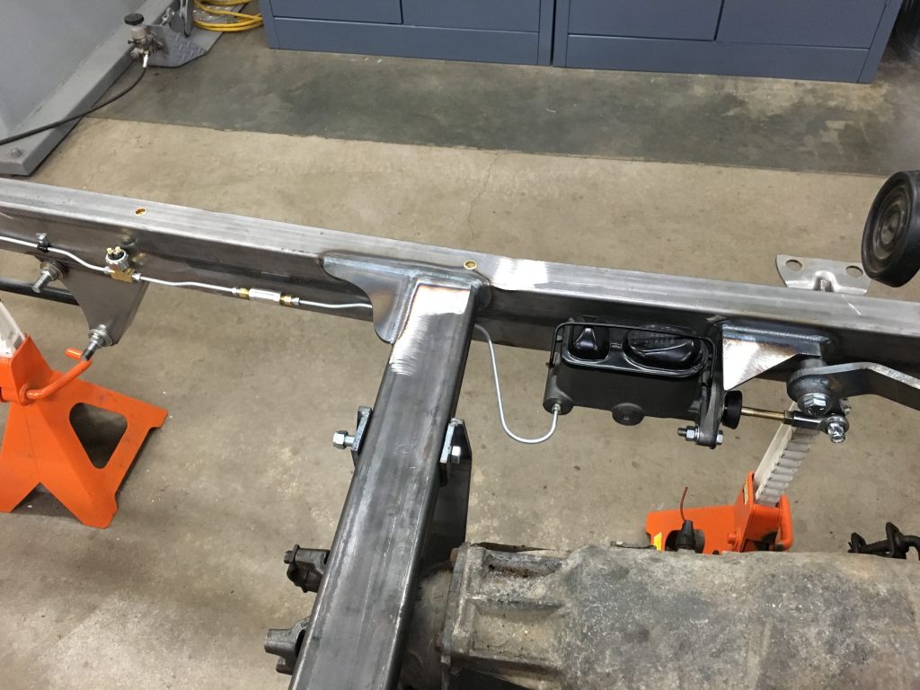 Here's an alt tag for the image: `Custom car frame with brake system`