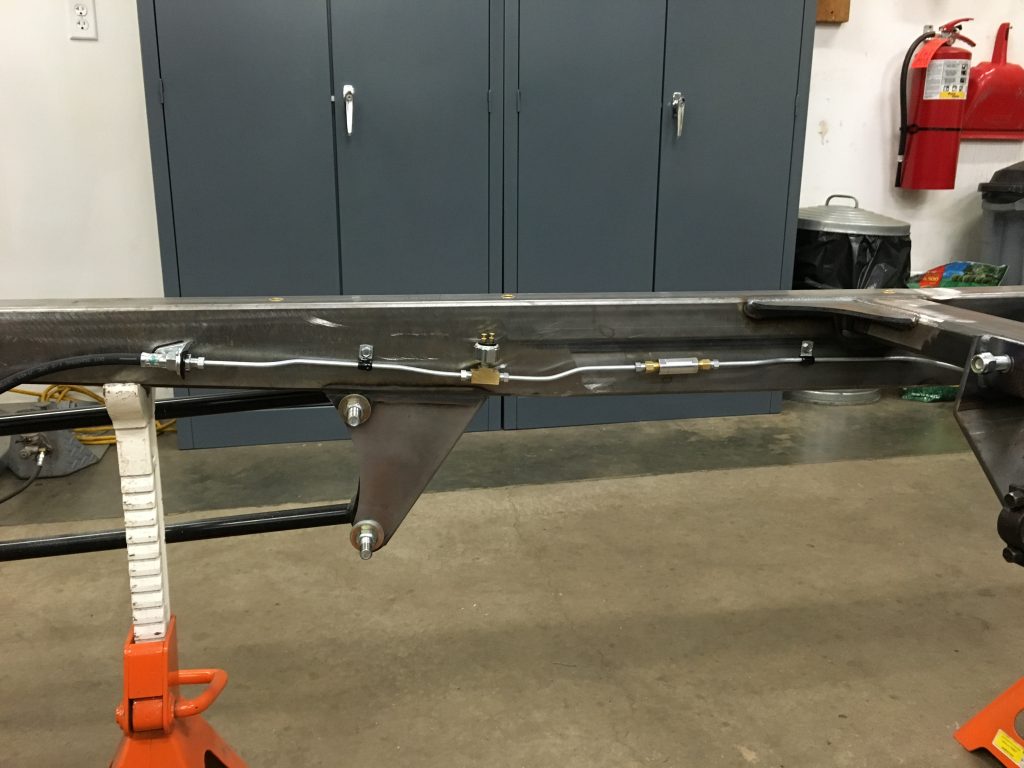 Custom car frame with brake lines.