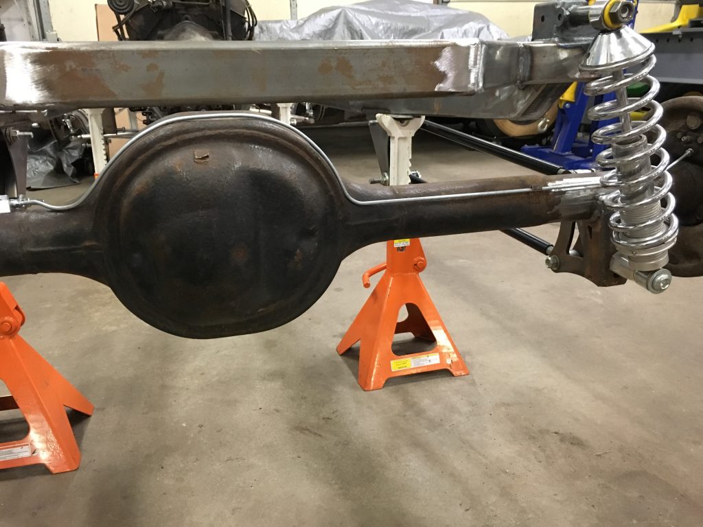 Here's an alt tag for the image: Rear end automotive chassis under construction.