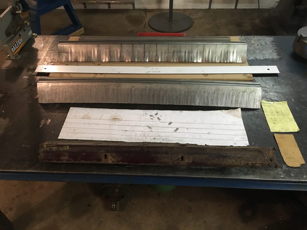 Metalwork in progress: templates and part.