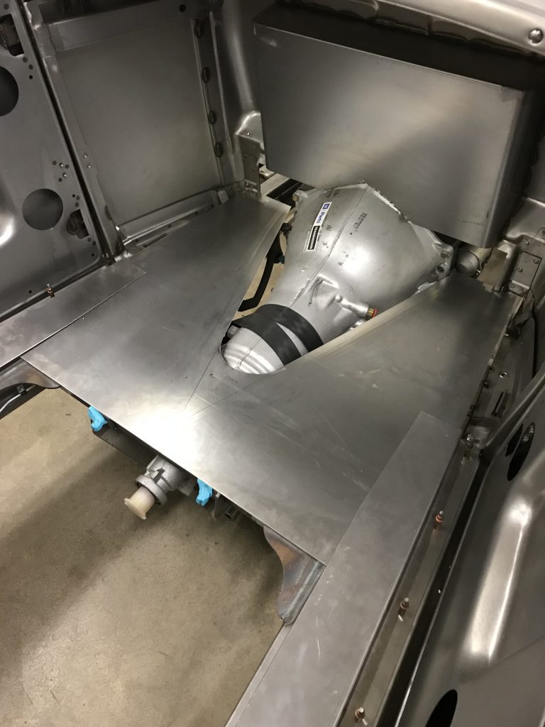 Car transmission installed in chassis.