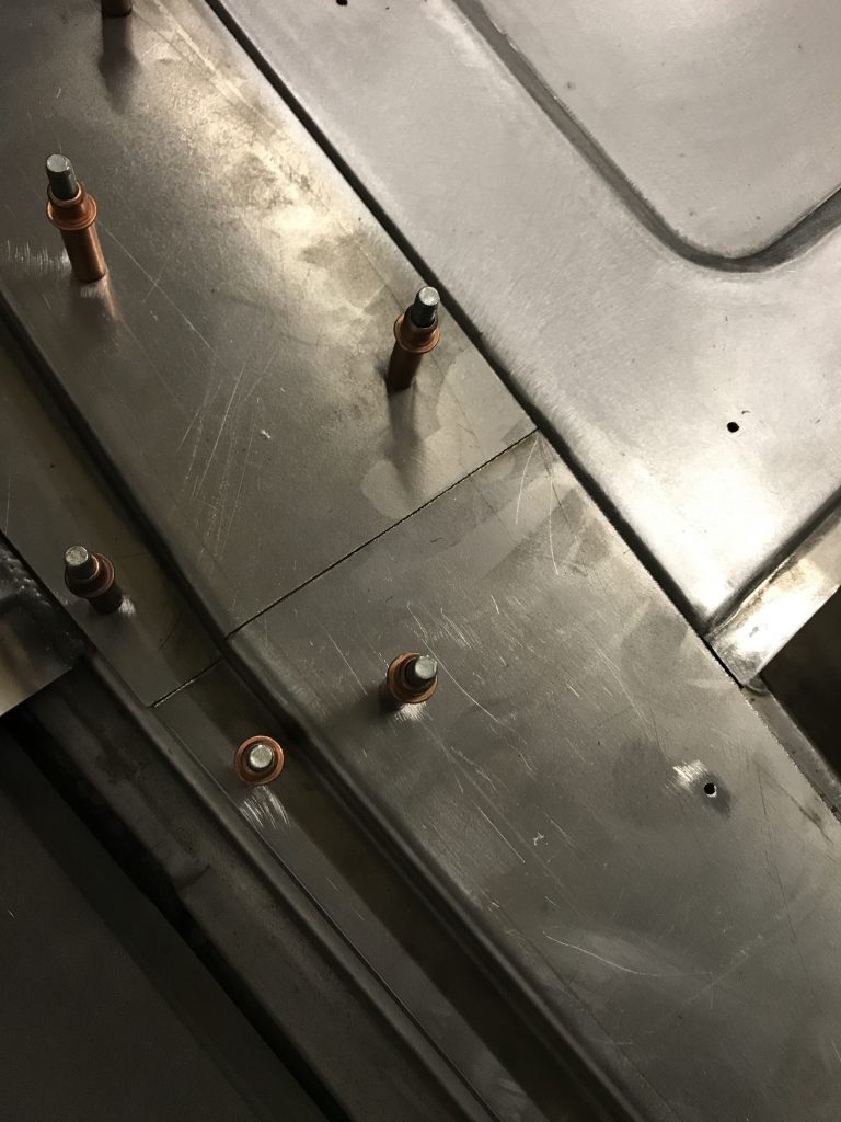 Metal sheet with rivets and fasteners.