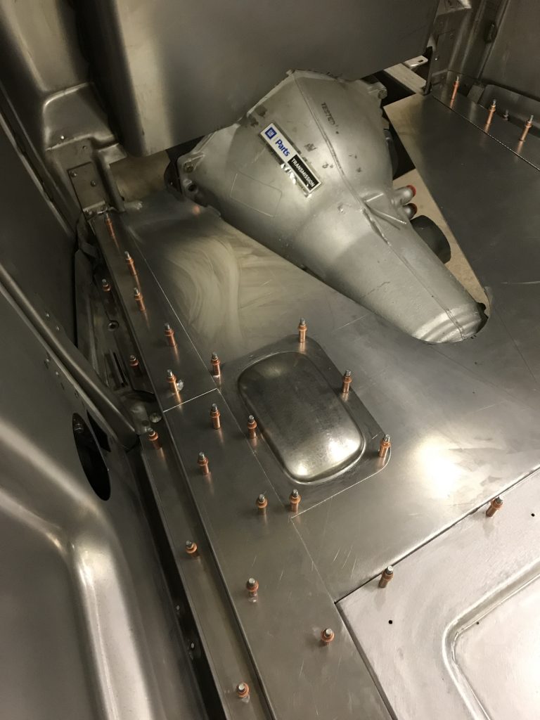 Car transmission installation in progress.