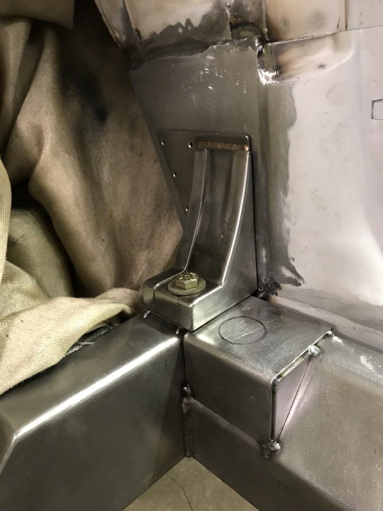 Welded metal bracket, bolted in place.