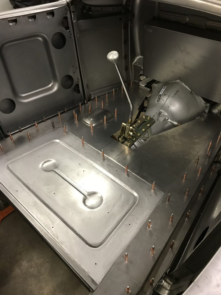 Hot rod car floor with transmission.