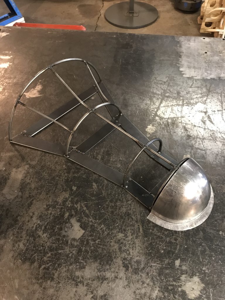 Metal frame with a curved metal panel.